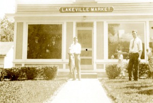 Dr. Hall with the monster lake trout in front of Goderis' Market, Lakeville, CT.